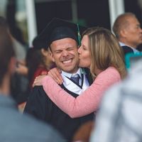 UFV grad getting kissed by his mom