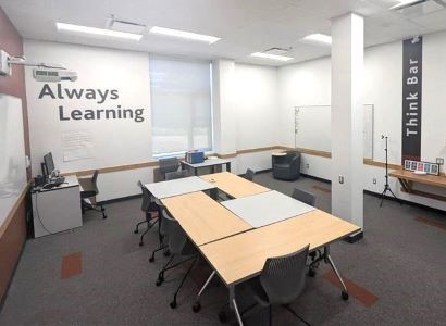 Room G124 shows tables and chairs with a whiteboard and projector and a snack bar